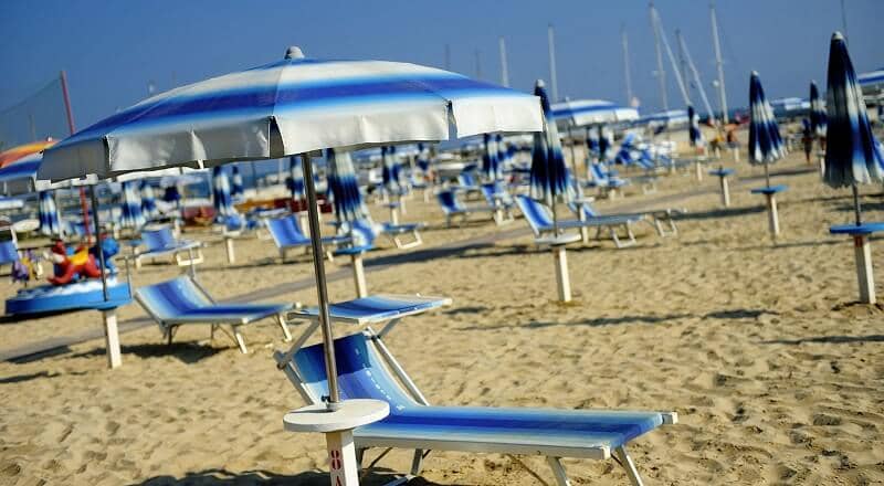 Cadeira e guarda-sol oferecidos em praia paga Cadeira e guarda-sol oferecidos em praia paga